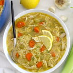Lemon Orzo Chicken Soup in white bowl with spoon on side