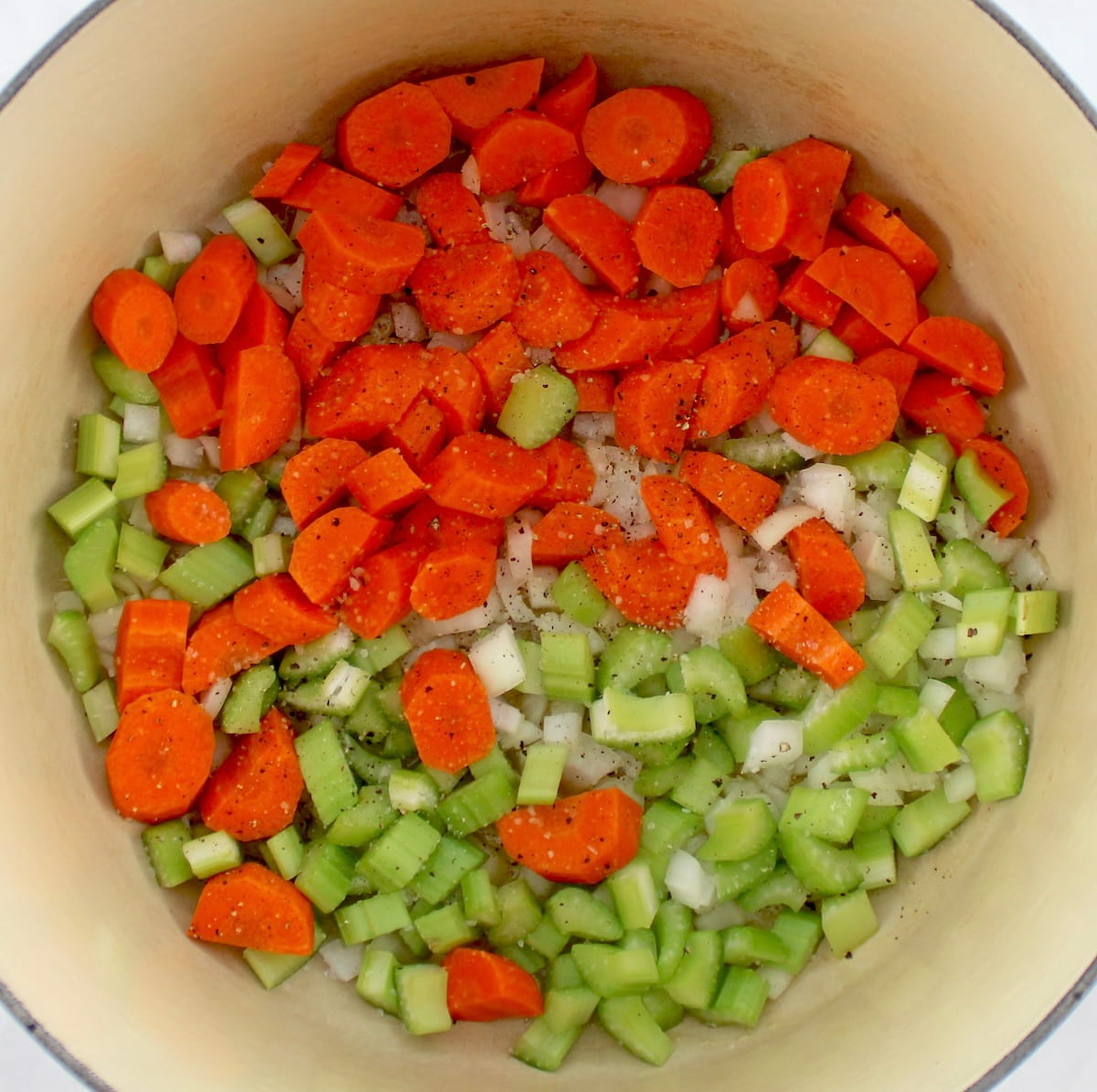 raw chopped carrots, celery and onions in dutch oven