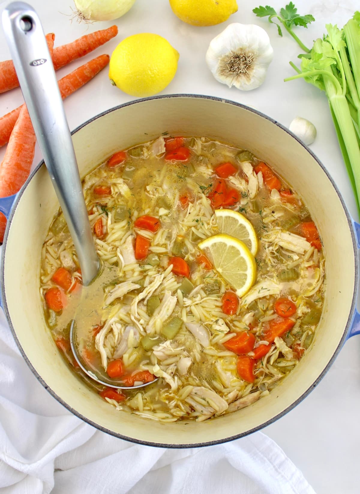 Lemon Orzo Chicken Soup in dutch oven with silver ladle