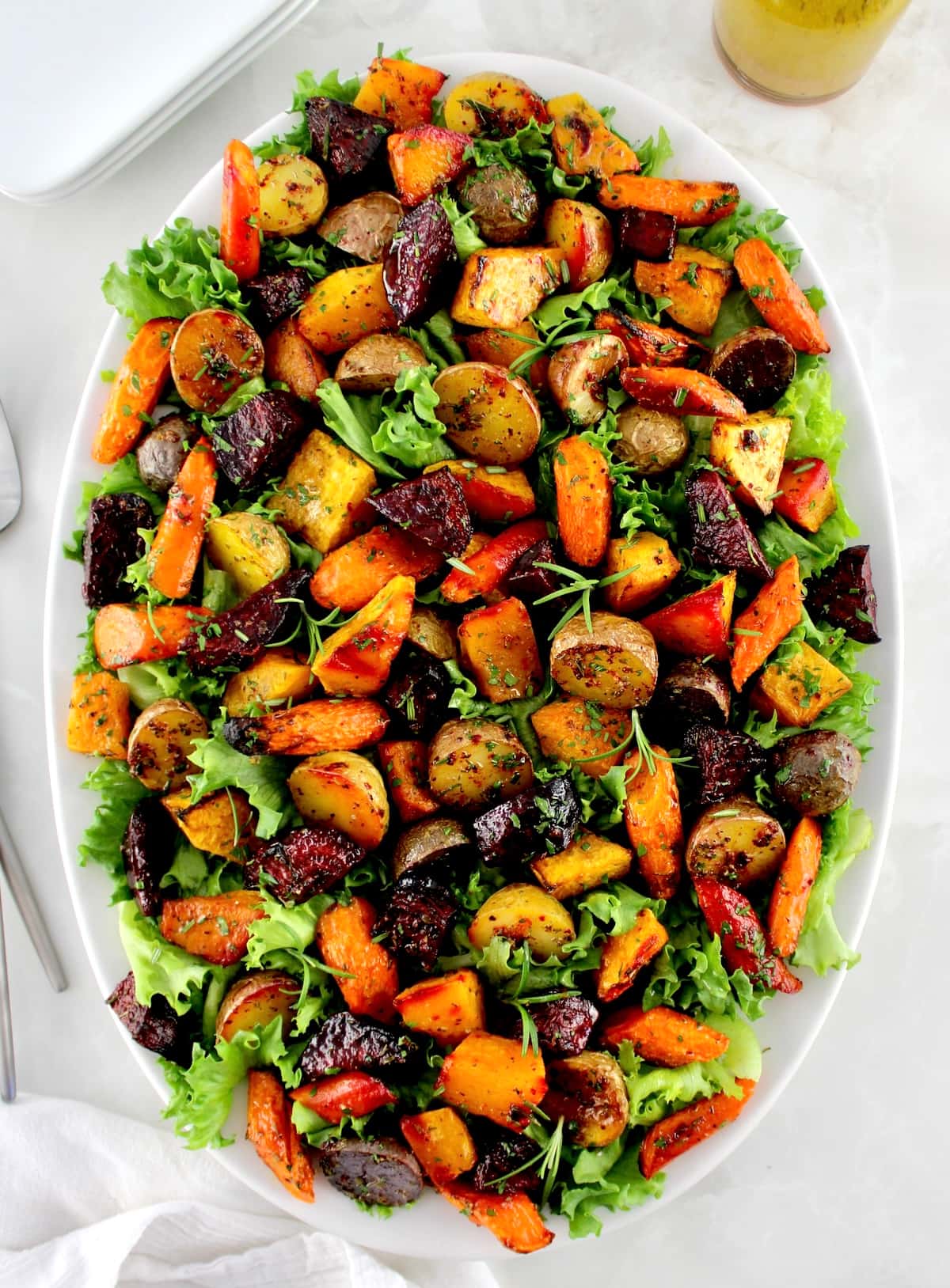 overhead view of Roasted Vegetable Salad on white oval platter