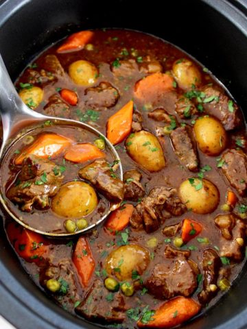 Slow Cooker Beef Stew with silver ladle in slow cooker insert