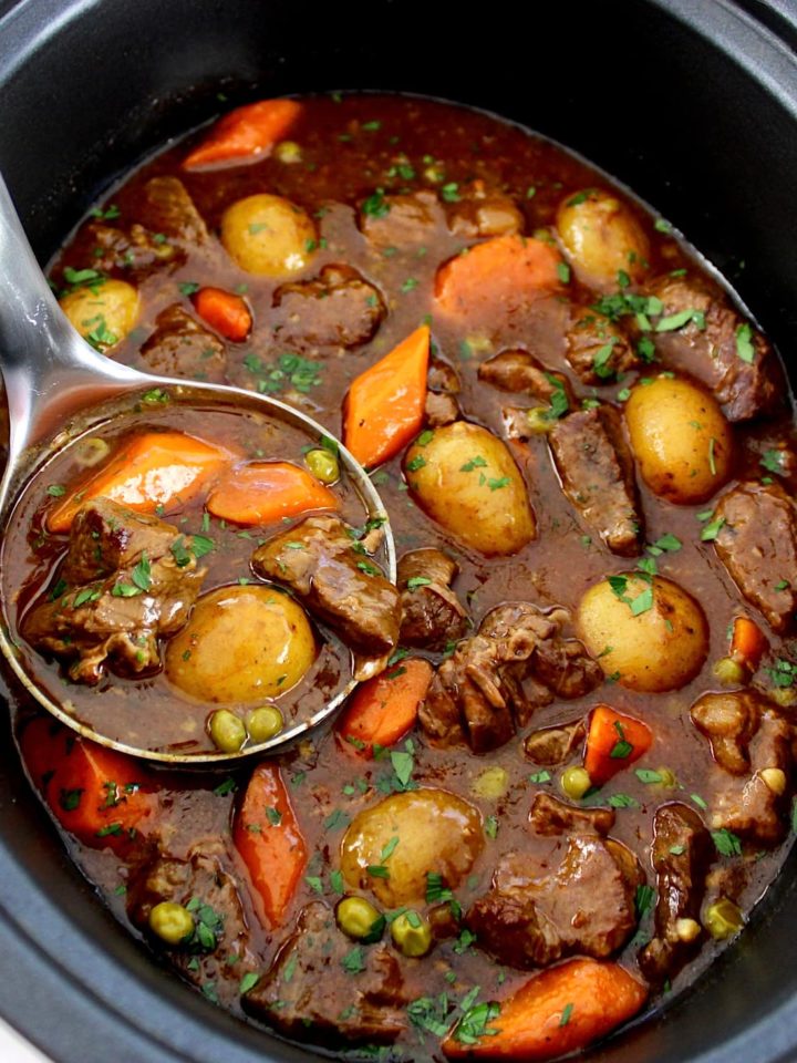 Slow Cooker Beef Stew with silver ladle in slow cooker insert