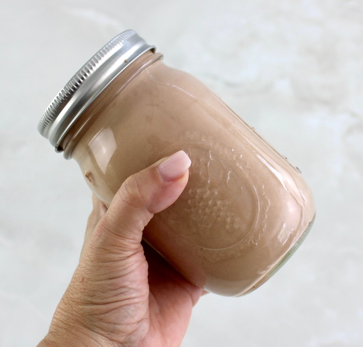 holding Mason Jar Chocolate Ice Cream in jar to shake