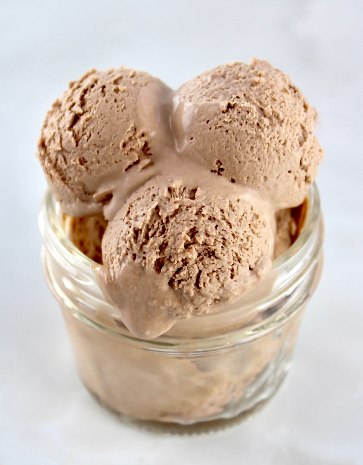 overhead view of 3 scoops of Mason Jar Chocolate Ice Cream in open jar