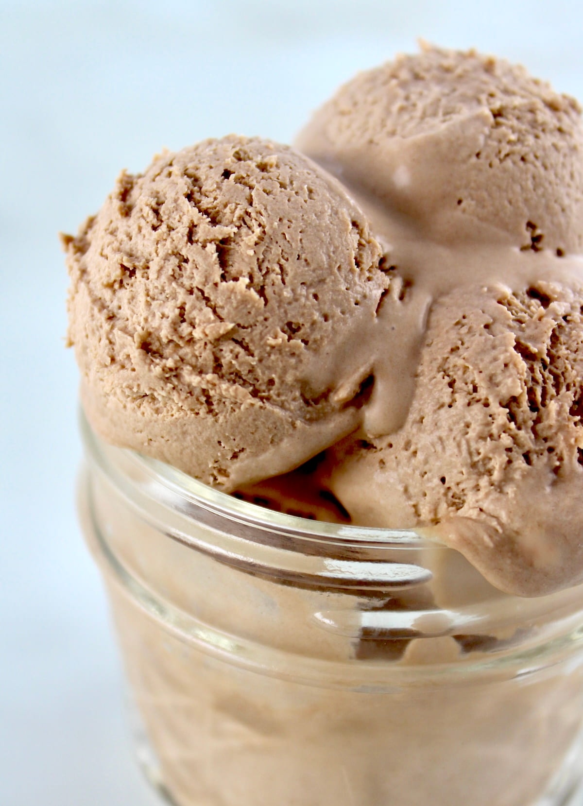 closeup of 3 scoops of Mason Jar Chocolate Ice Cream in open glass jar
