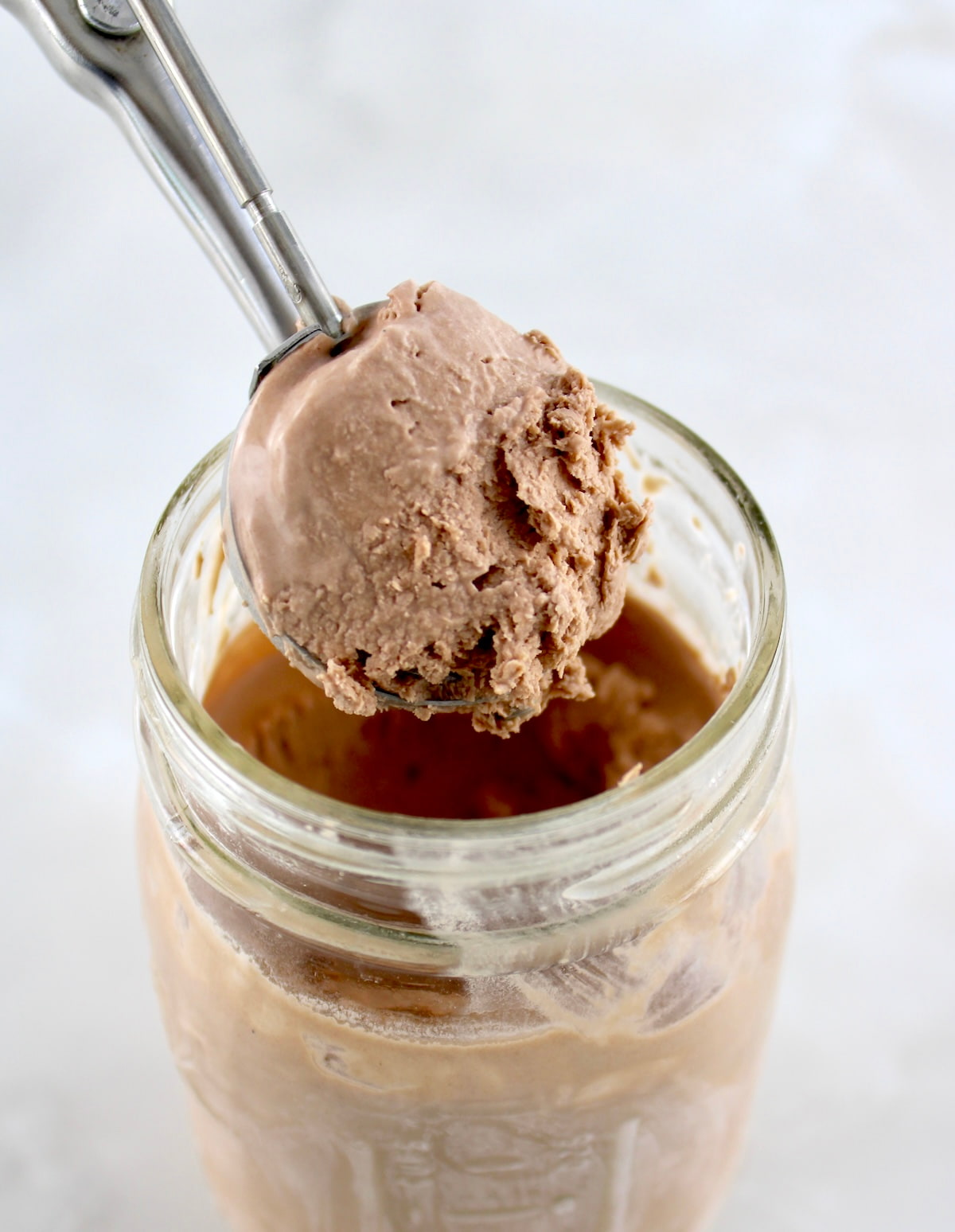 Mason Jar Chocolate Ice Cream being scooped with ice cream scooper out of jar