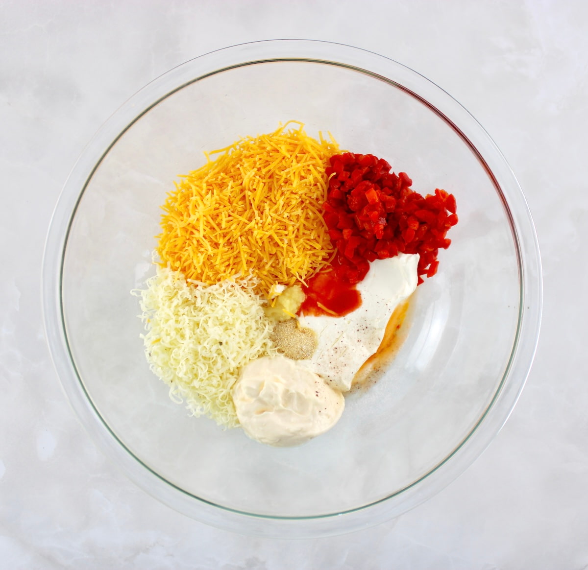 Pimento Cheese Spread ingredients in glass bowl unmixed