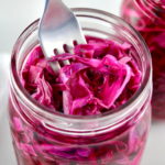 Easy Pickled Red Cabbage in open glass jar with fork stuck in