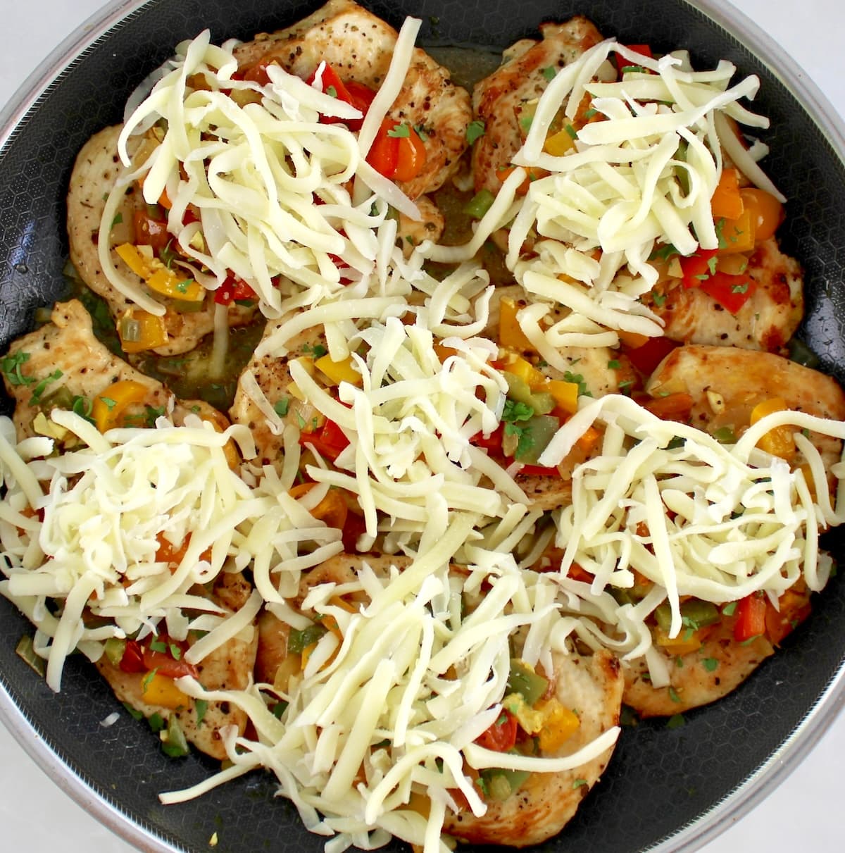 Fiesta Chicken Skillet with shredded mozzarella in skillet