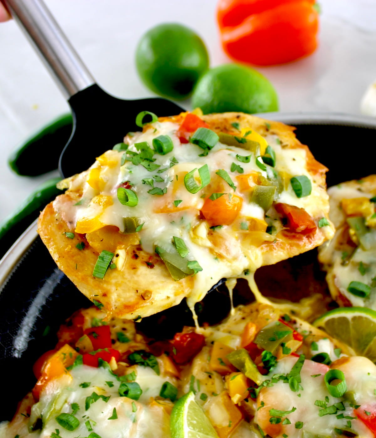 lifting piece of Fiesta Chicken Skillet out with spatula