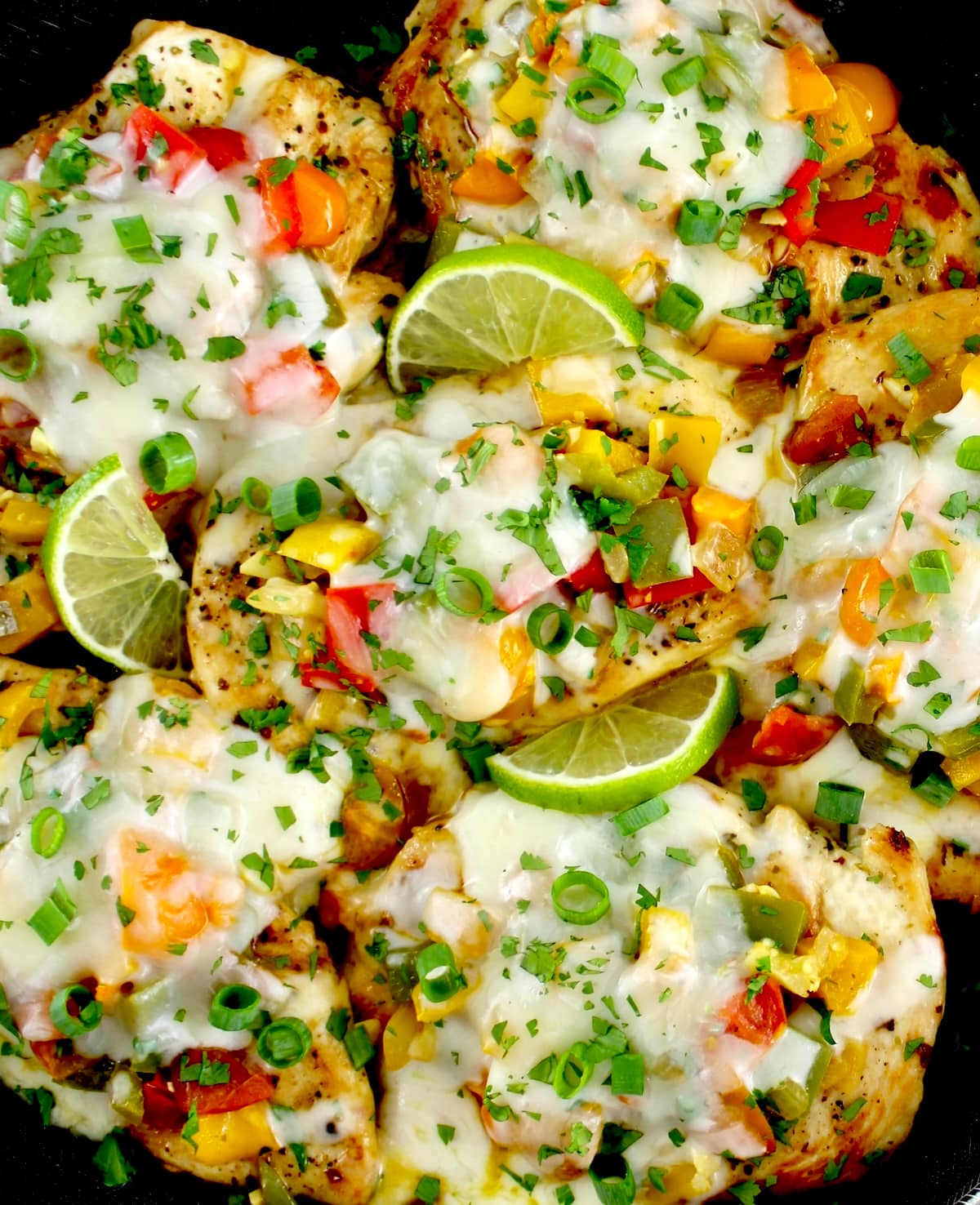 overhead closeup of Fiesta Chicken Skillet with lime slices and chopped cilantro