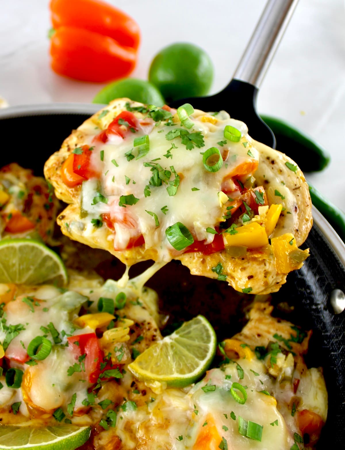 lifting up Fiesta Chicken in spatula over skillet