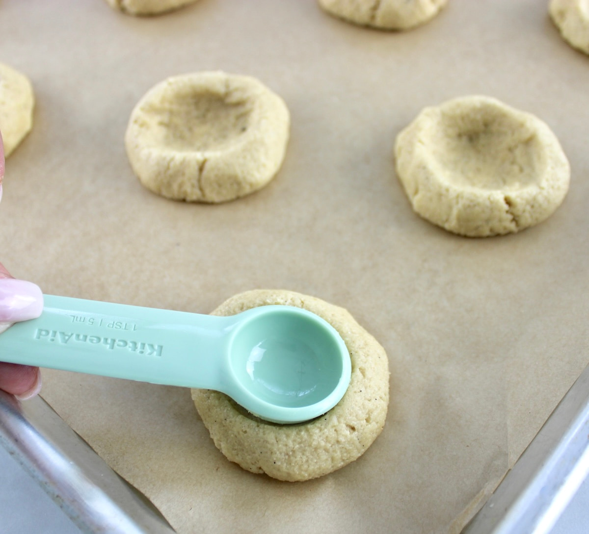 Pecan Pie Cookie dough with measuring spoon pressing in the center