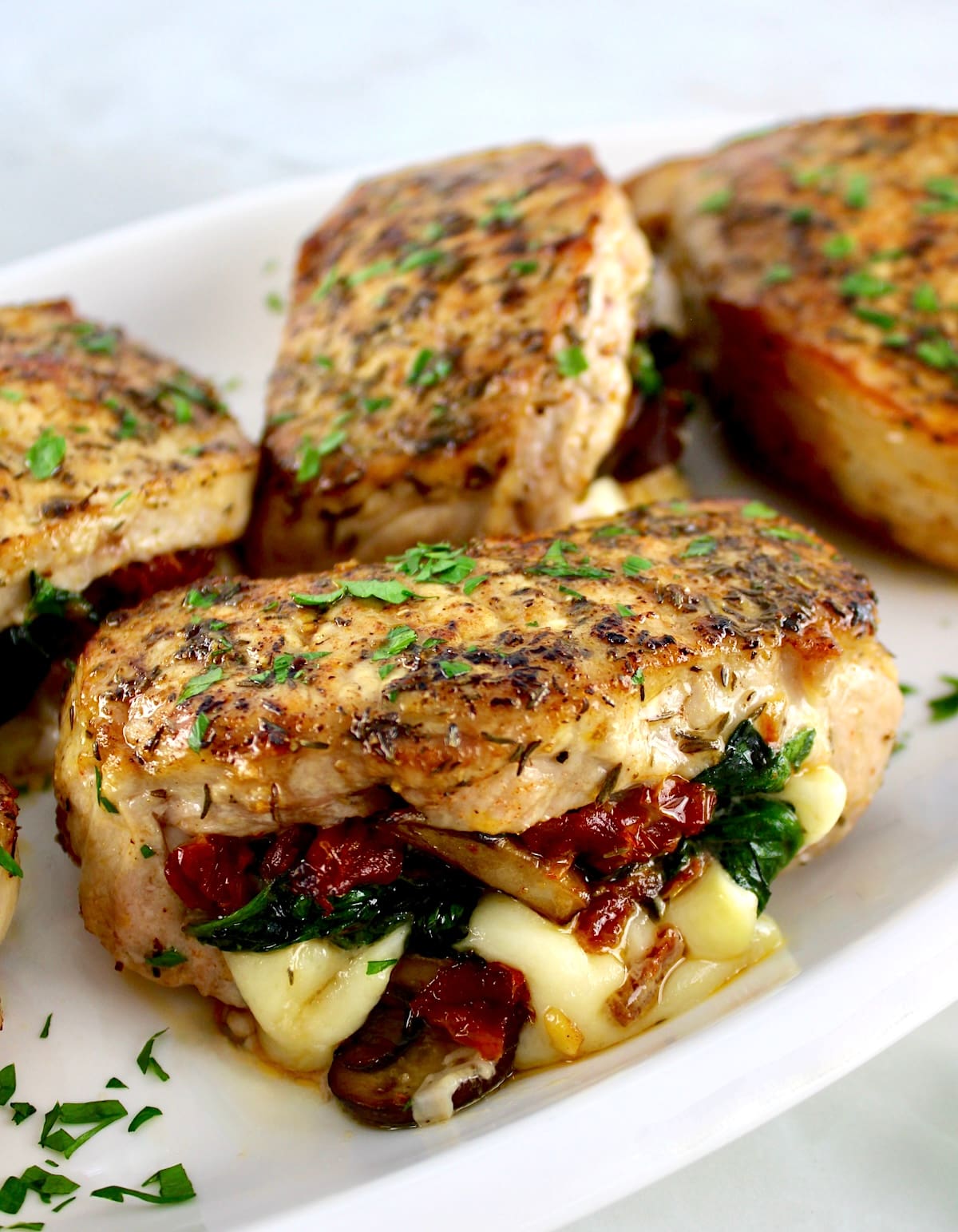 Stuffed Pork Chops on white plate