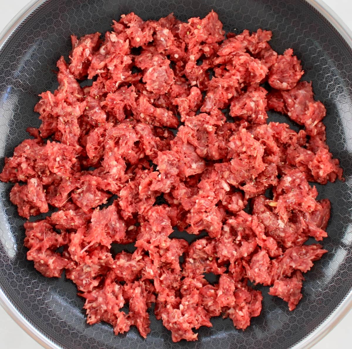 raw ground beef in skillet