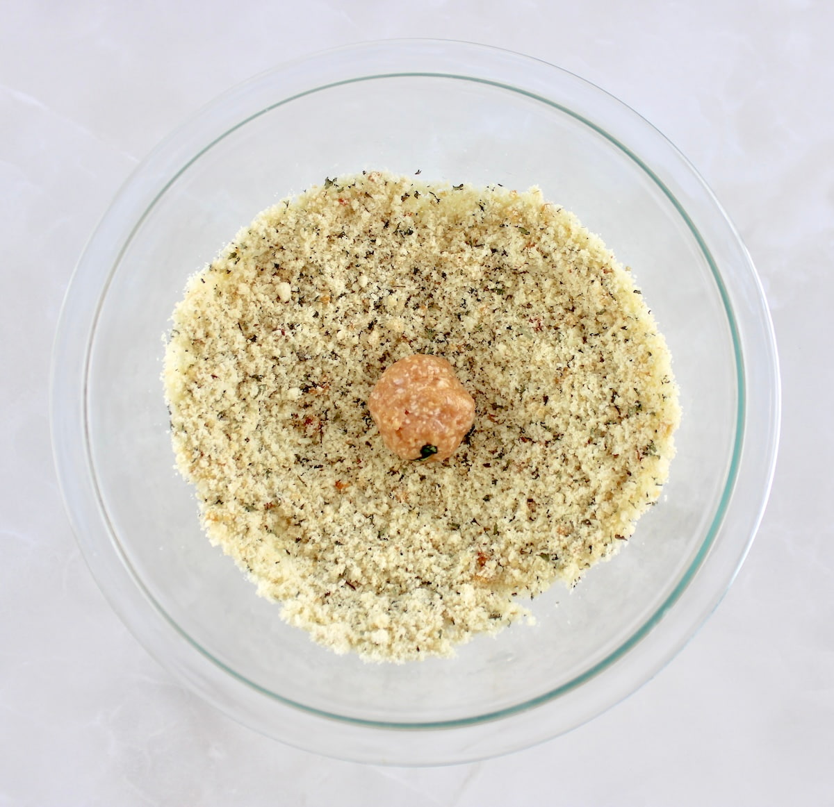 Chicken Parmesan Meatball in breading in glass bowl
