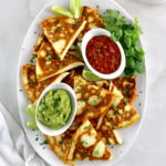 overhead view of Chicken Quesadillas on white oval platter
