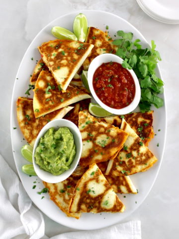 overhead view of Chicken Quesadillas on white oval platter
