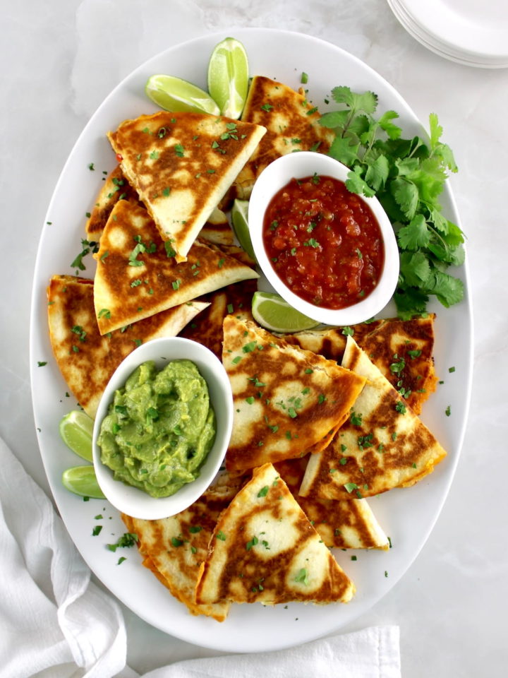 overhead view of Chicken Quesadillas on white oval platter