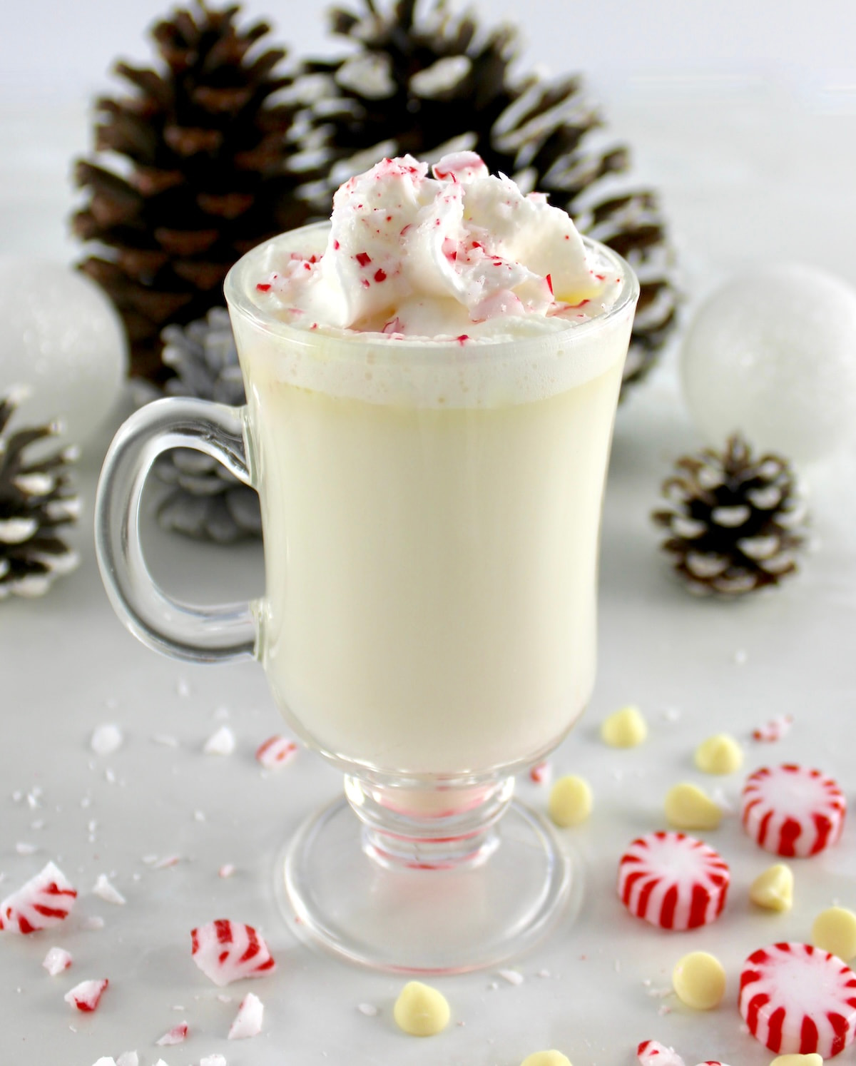 Peppermint White Hot Chocolate in glass with whip cream and crushed peppermint on top