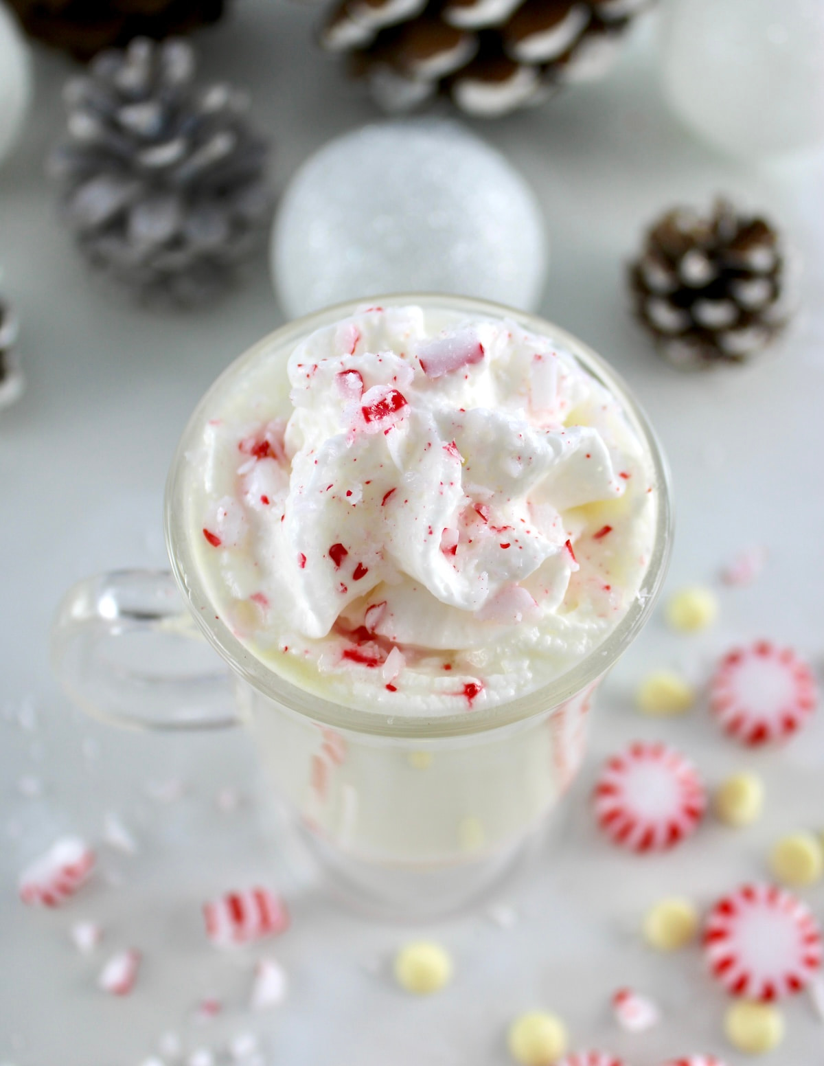 overhead view of Peppermint White Hot Chocolate with whip cream and crushed peppermints on top
