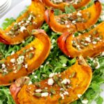 Roasted Pumpkin wedges on bed of arugula with pumpkin seeds and feta on top