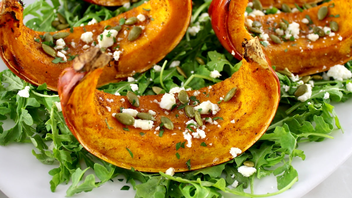 closeup of Roasted Pumpkin on bed of arugula