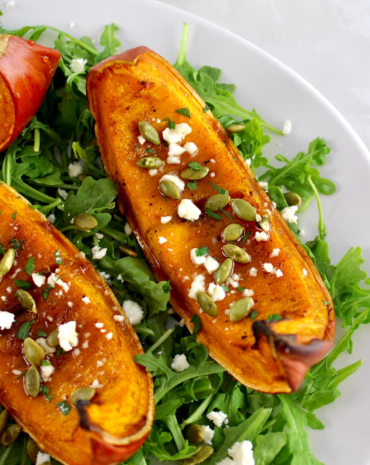closeup of Roasted Pumpkin on arugula
