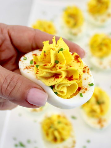 holding up Classic Deviled Egg