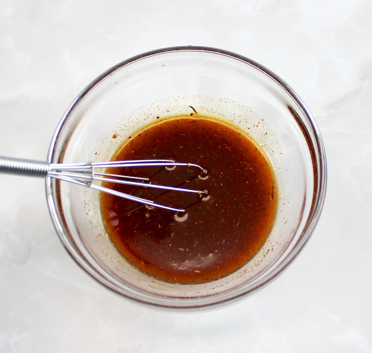 Cajun Salmon Bites sauce in glass bowl with whisk