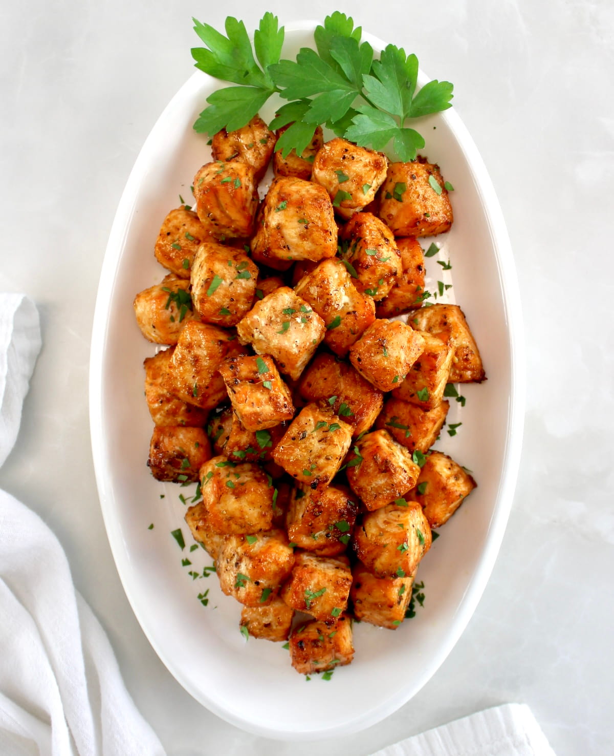 overhead view of Cajun Salmon Bites in white oval platter