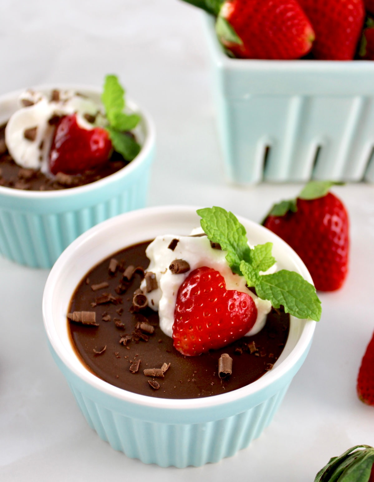 Chocolate Pots de Crème in ramekin with whip cream and a strawberry on top