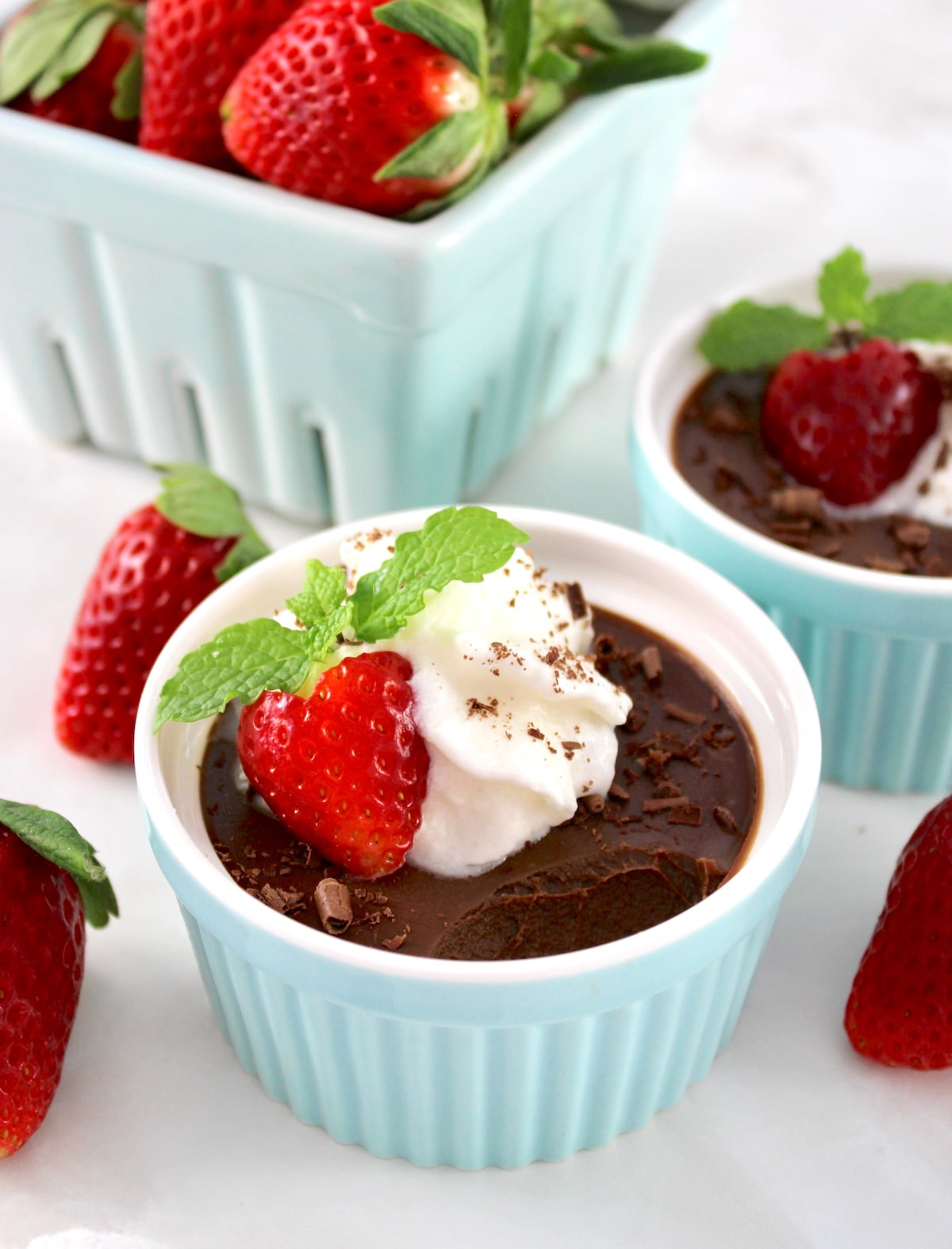 Chocolate Pots de Crème in ramekin with whip cream and a strawberry on top
