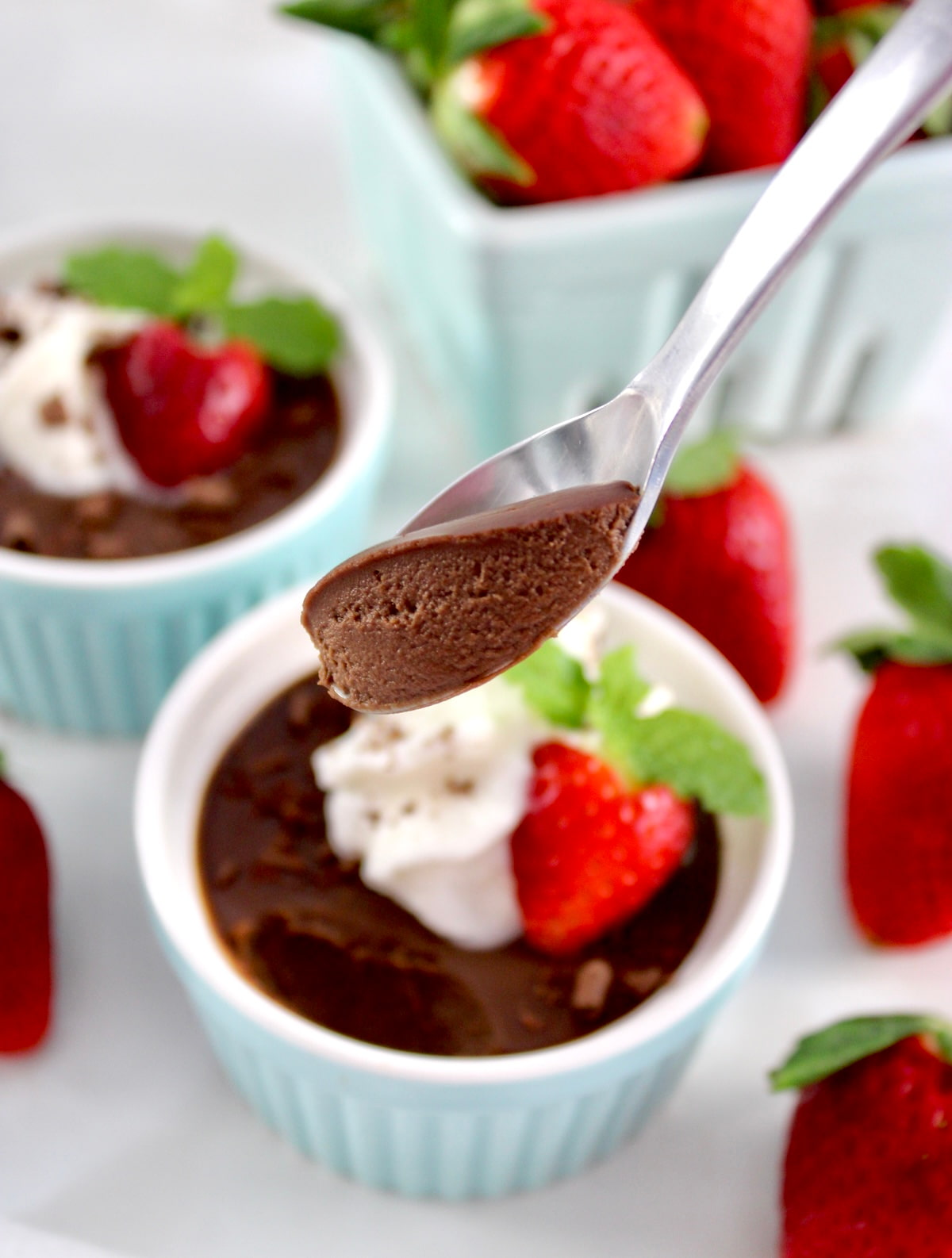 Chocolate Pots de Crème in spoon held up over ramekin