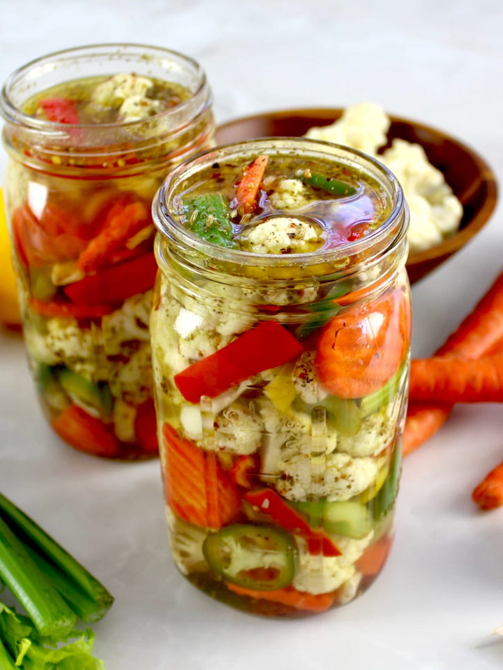 Easy Homemade Giardiniera in glass jar with veggies in back