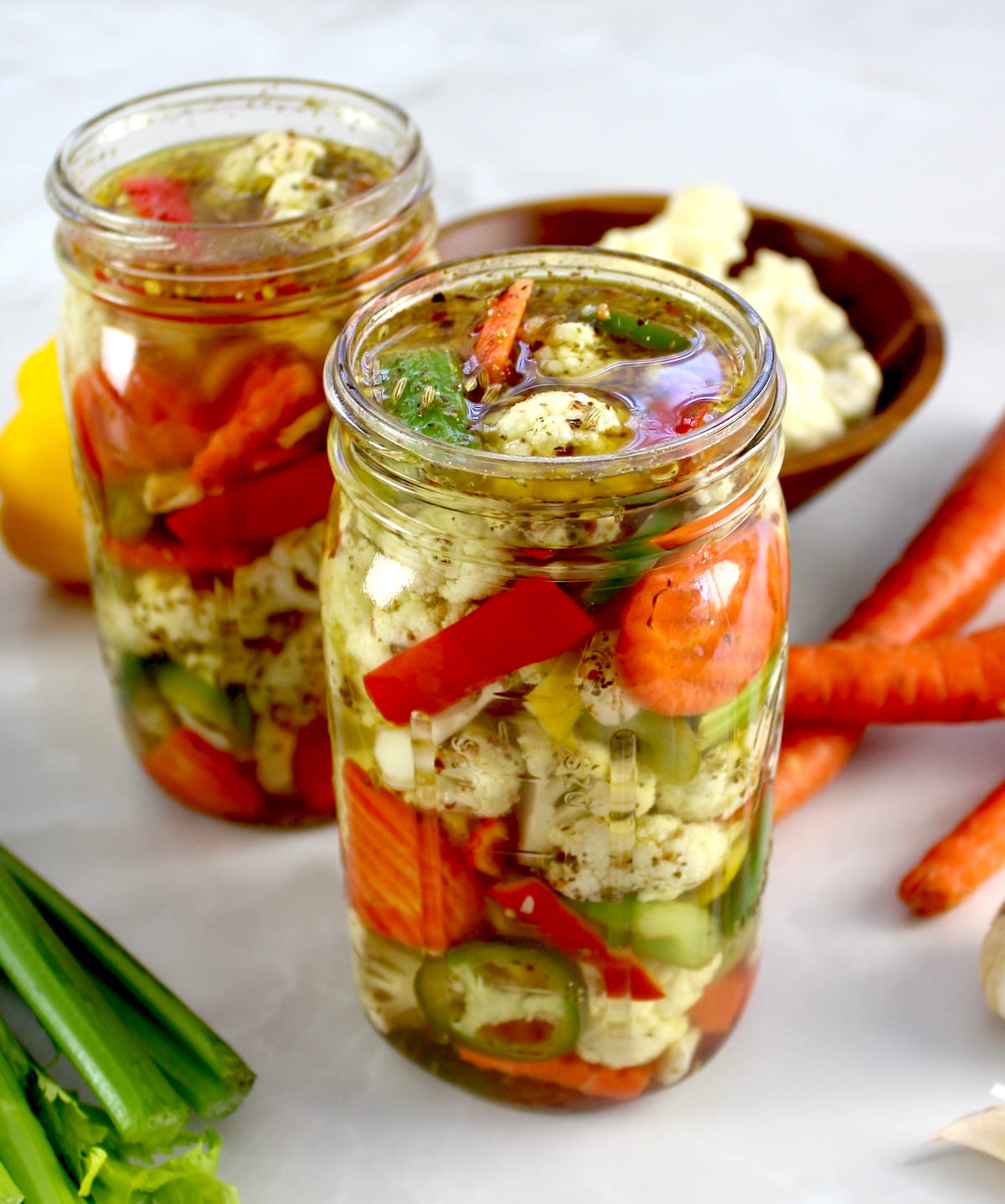 Easy Homemade Giardiniera in glass jar with veggies in back
