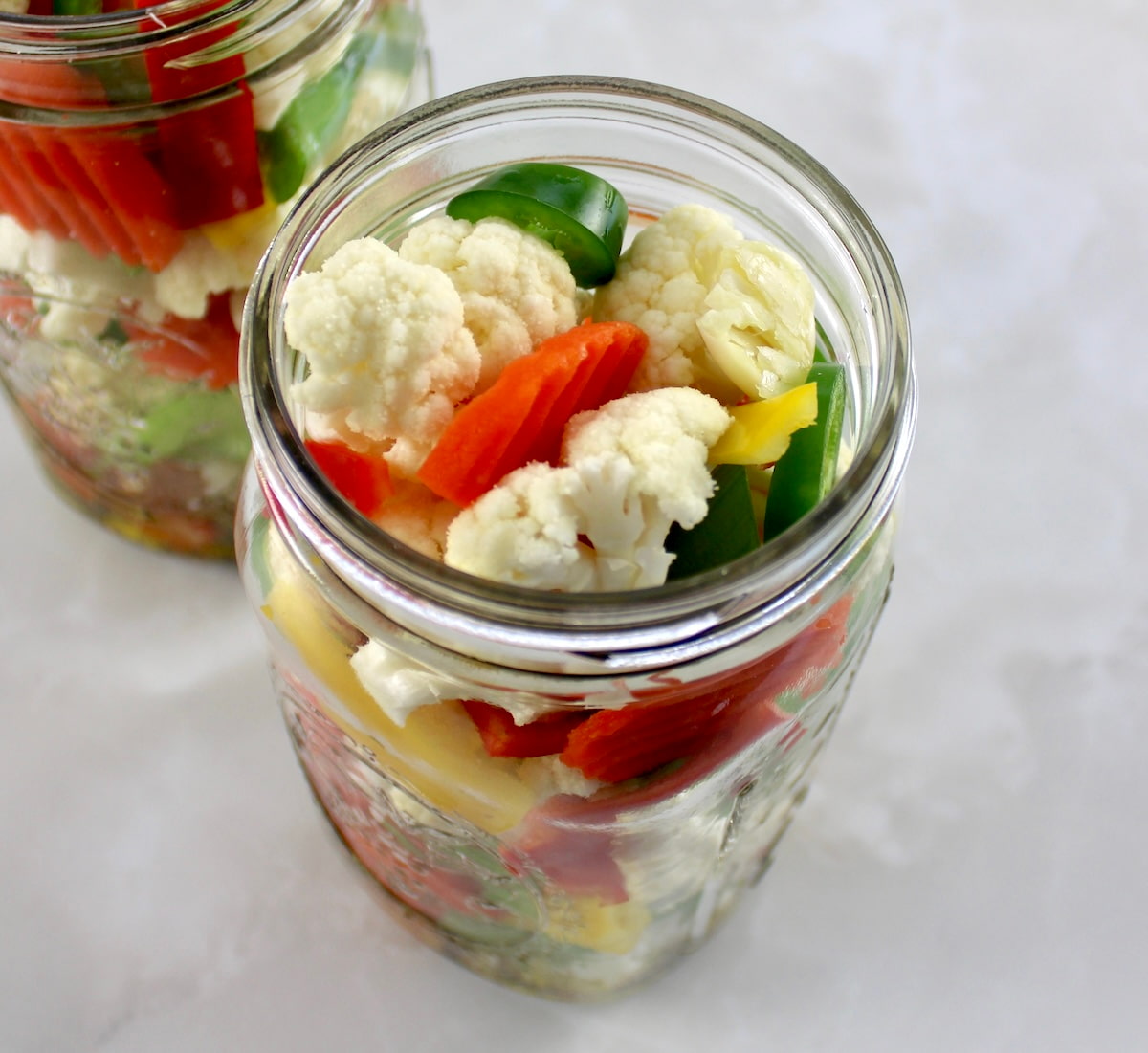 Easy Homemade Giardiniera veggies in open glass jar