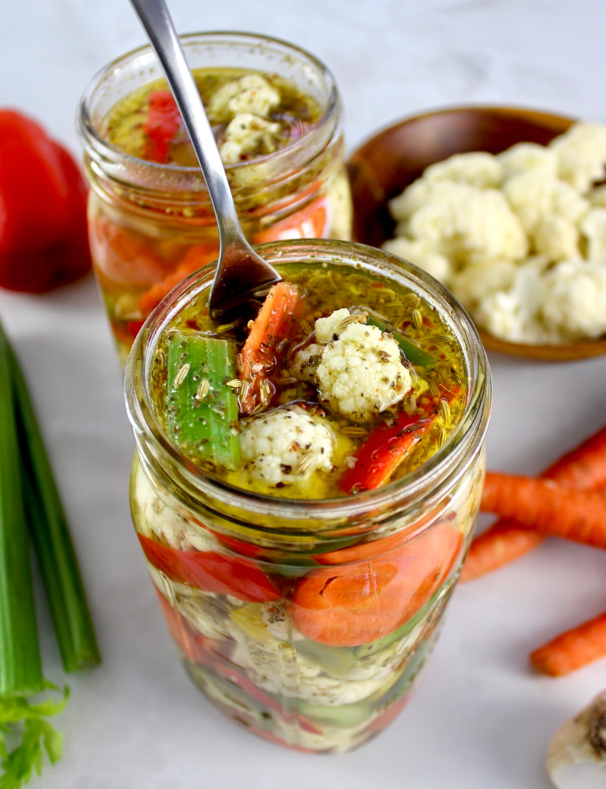 Easy Homemade Giardiniera in open glass jar with fork lifting out some