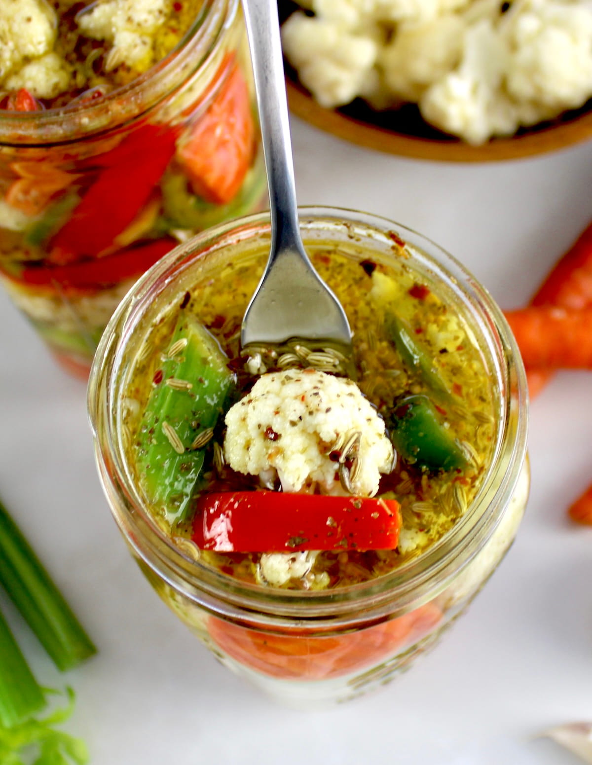 Easy Homemade Giardiniera in open glass jar with fork lifting out some
