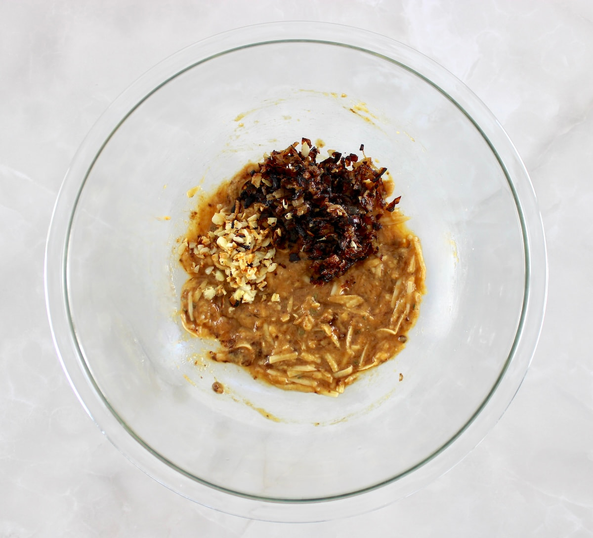 French Onion Meatloaf ingredients in glass bowl with caramelized onions and garlic