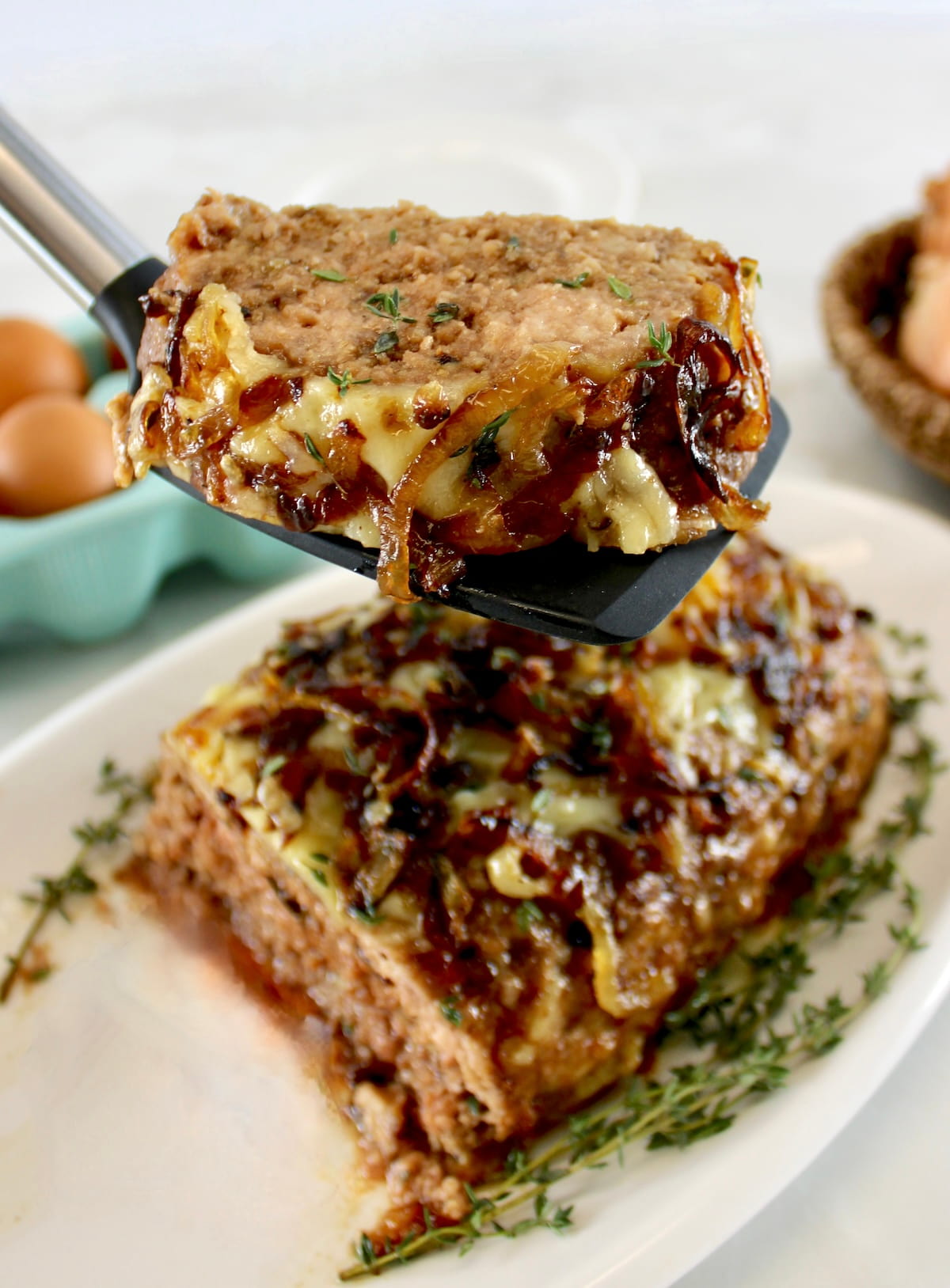 spatula holding up slice of French Onion Meatloaf