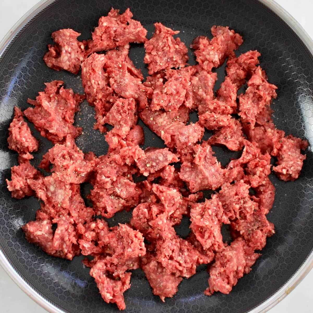 raw ground beef in skillet