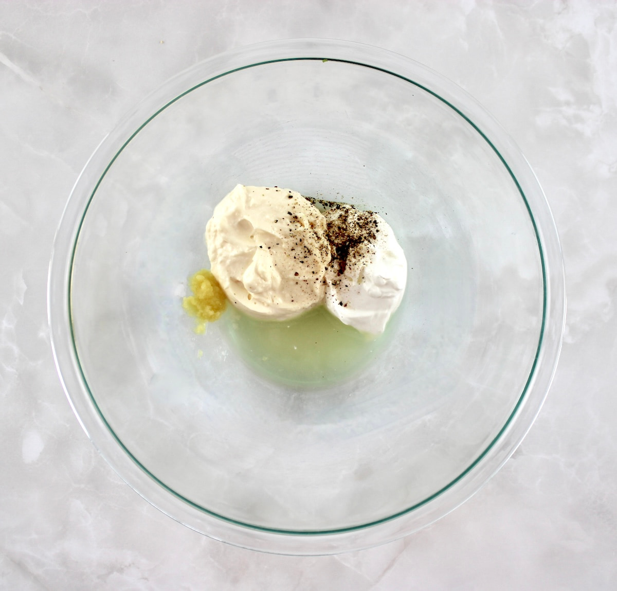 Spinach Artichoke Chicken Salad dressing ingredients in glass bowl unmixed