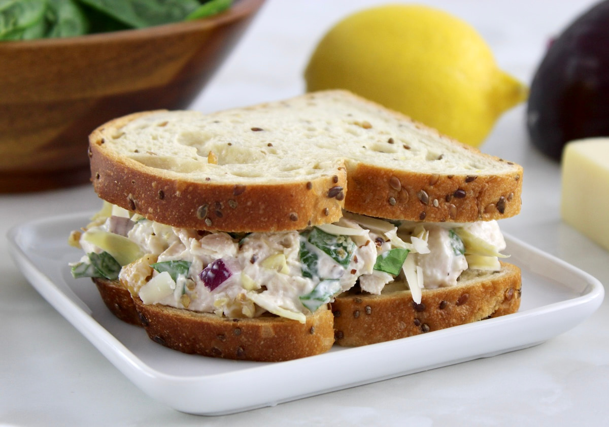 closeup of Spinach Artichoke Chicken Salad on Sola bread