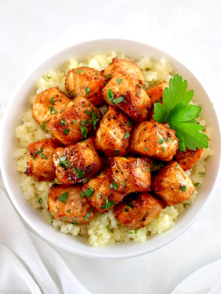 overhead view of Cajun Salmon Bites in bowl with cauliflower rice