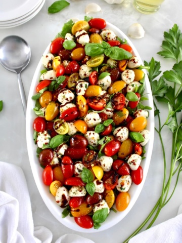 overhead view of Chopped Caprese Salad on white oval platter