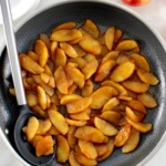 Easy Cinnamon Apples in skillet with serving spoon on side
