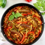 overhead view of Italian Sausage and Peppers Cabbage Skillet with fresh basil garnish