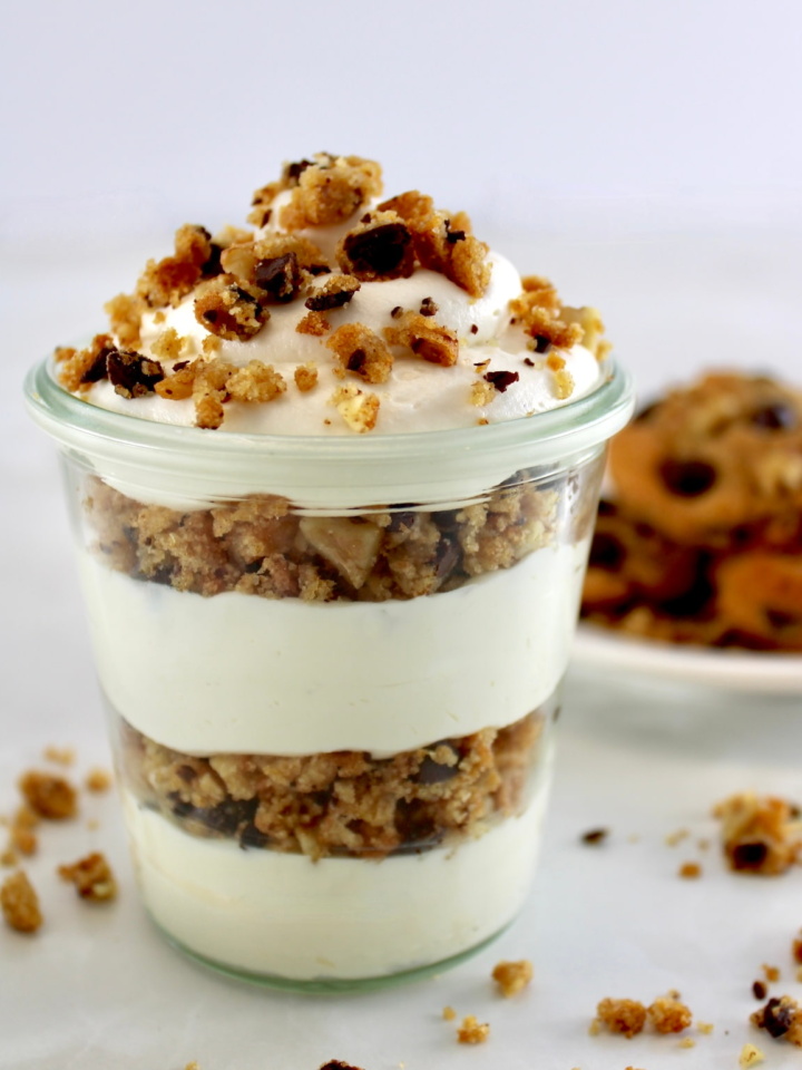 Chocolate Chip Cookie Cheesecake Parfaits in glass jar with cookies in back