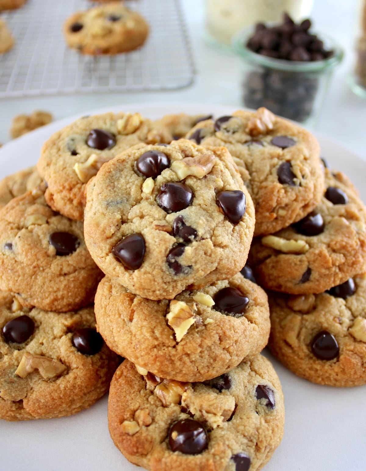 Chocolate Chip Walnut Cookies stacked up on white plate